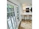Bright kitchen with a breakfast bar overlooks a private patio with chairs and lush greenery at 102 Adrian Nw Pl, Atlanta, GA 30327