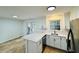 Modern kitchen featuring white cabinets, countertop seating, and backyard access at 102 Adrian Nw Pl, Atlanta, GA 30327