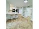 Modern kitchen boasts sleek countertops, stainless steel appliances, and stylish herringbone wood floors at 102 Adrian Nw Pl, Atlanta, GA 30327