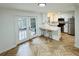 Bright, open kitchen with white cabinets, stainless steel appliances, and backyard views at 102 Adrian Nw Pl, Atlanta, GA 30327
