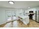 White kitchen featuring stainless steel appliances, countertop seating, and double doors at 102 Adrian Nw Pl, Atlanta, GA 30327