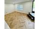 Living room with hardwood floors and a large window with shutter style blinds at 102 Adrian Nw Pl, Atlanta, GA 30327