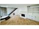 Bright living room with a fireplace and stunning herringbone floors throughout the living space at 102 Adrian Nw Pl, Atlanta, GA 30327