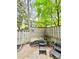 Cozy patio with outdoor seating, enclosed by a wooden fence with decorative string lights at 102 Adrian Nw Pl, Atlanta, GA 30327