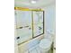 Enclosed shower and tub featuring glass doors and white tiled walls at 102 Adrian Nw Pl, Atlanta, GA 30327
