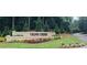 A beautiful stone sign welcomes residents and guests to Cross Creek with manicured landscaping at 102 Adrian Nw Pl, Atlanta, GA 30327