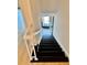 Staircase with black painted stairs and a white banister leading to the next level of the home at 102 Adrian Nw Pl, Atlanta, GA 30327