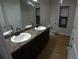 Bathroom boasts double sinks, wooden floors, and modern fixtures for a luxurious feel at 2362 Glebe Ct, Hampton, GA 30228