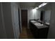 Bathroom features double sinks and a well-lit mirror, offering a practical and stylish space at 2362 Glebe Ct, Hampton, GA 30228