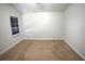 Carpeted bedroom featuring natural light from one window, creates a bright and comfortable space at 2362 Glebe Ct, Hampton, GA 30228