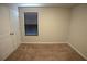 This carpeted bedroom features neutral walls and one window, offering a clean and comfortable space at 2362 Glebe Ct, Hampton, GA 30228