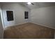 Carpeted bedroom featuring a vaulted ceiling, ceiling fan and natural light from one window at 2362 Glebe Ct, Hampton, GA 30228