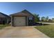 Single-car garage with driveway, situated on a well-maintained lawn and curb appeal at 2362 Glebe Ct, Hampton, GA 30228