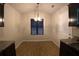 Eat-in kitchen featuring dark cabinets, hardwood flooring and a stylish chandelier at 2362 Glebe Ct, Hampton, GA 30228