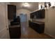 Eat-in kitchen with dark cabinets, stainless steel appliances, and an open floor plan at 2362 Glebe Ct, Hampton, GA 30228