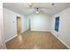 Spacious living area with versatile flooring, ceiling fan, and access to other rooms at 2362 Glebe Ct, Hampton, GA 30228