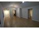 Open-concept living area flows seamlessly, featuring modern lighting and laminate flooring at 2362 Glebe Ct, Hampton, GA 30228