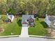 Aerial view of a brick home with a well-manicured lawn and mature trees in a suburban setting at 2523 Bancroft Way, Buford, GA 30519