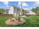 Spacious backyard featuring a stone fire pit, outdoor seating, and a patio with pergola at 2523 Bancroft Way, Buford, GA 30519