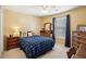Comfortable bedroom featuring a plaid coverlet, wooden furniture, and a well-lit window at 2523 Bancroft Way, Buford, GA 30519