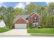 Charming brick home with a well-manicured lawn, two-car garage, and lush landscaping at 2523 Bancroft Way, Buford, GA 30519