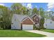 A well maintained two-story brick home with attached garage on a lush green lawn at 2523 Bancroft Way, Buford, GA 30519