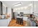 Bright kitchen with white cabinets, stainless steel appliances, and tile backsplash at 2523 Bancroft Way, Buford, GA 30519