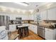 Bright kitchen with white cabinets, stainless steel appliances, and granite countertops at 2523 Bancroft Way, Buford, GA 30519