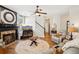 Inviting living room with a fireplace, hardwood floors, ceiling fan, and comfortable seating at 2523 Bancroft Way, Buford, GA 30519