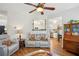 Open-concept living room with hardwood floors and view into the bright white kitchen at 2523 Bancroft Way, Buford, GA 30519