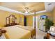 Spacious primary bedroom with a large bed, a ceiling fan, and ample natural light at 2523 Bancroft Way, Buford, GA 30519