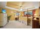 Luxurious primary bedroom with tray ceilings, a ceiling fan, and large windows at 2523 Bancroft Way, Buford, GA 30519