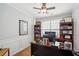 A well lit home office space with built-in bookshelves and a large desk setup at 2523 Bancroft Way, Buford, GA 30519