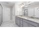 Elegant bathroom featuring a double vanity with granite countertops, marble floors, and a glass-enclosed shower at 333 Gardens Of Harmony Dr, Canton, GA 30115