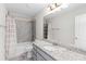 Clean bathroom with granite countertop vanity, shower-tub combo and elegant neutral color palette at 333 Gardens Of Harmony Dr, Canton, GA 30115