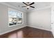 Bright bedroom with a large window offering neighborhood views and wood flooring at 333 Gardens Of Harmony Dr, Canton, GA 30115
