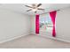 The bedroom includes a ceiling fan, and a window overlooking a neighborhood at 333 Gardens Of Harmony Dr, Canton, GA 30115