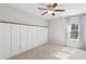 A cozy bedroom with board and batten accent wall and a window dressed with sheer curtains at 333 Gardens Of Harmony Dr, Canton, GA 30115