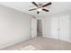 A standard bedroom with neutral walls, carpeted floor, a ceiling fan and double door closet at 333 Gardens Of Harmony Dr, Canton, GA 30115