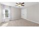 Bright bedroom features neutral walls, carpet, ceiling fan, natural light, and closet space at 333 Gardens Of Harmony Dr, Canton, GA 30115