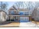 Beautiful two-story home with brick and gray siding, a two-car garage, and a well-kept lawn, perfect for Gathering living at 333 Gardens Of Harmony Dr, Canton, GA 30115