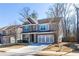 Charming two-story home featuring a brick and gray exterior, attached garage, and a well-manicured front lawn at 333 Gardens Of Harmony Dr, Canton, GA 30115
