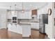 Open kitchen with white cabinets, granite countertops, stainless steel appliances and a stylish island at 333 Gardens Of Harmony Dr, Canton, GA 30115
