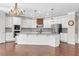 Gourmet kitchen featuring white cabinets, stainless steel appliances, granite countertops, and a large center island at 333 Gardens Of Harmony Dr, Canton, GA 30115
