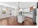 Bright open kitchen with stainless appliances, a center island, and hardwood floors, ideal for modern living at 333 Gardens Of Harmony Dr, Canton, GA 30115