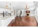 Open layout of kitchen and living room, featuring stainless steel appliances and a cozy fireplace at 333 Gardens Of Harmony Dr, Canton, GA 30115