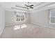 Large main bedroom with a trey ceiling, ceiling fan, and sunlit windows at 333 Gardens Of Harmony Dr, Canton, GA 30115