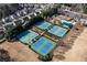 Aerial view showcasing a tennis court complex surrounded by residential homes and greenery at 333 Gardens Of Harmony Dr, Canton, GA 30115