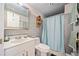 Bathroom featuring tiled walls, a sink with vanity, a toilet, and a shower with a curtain at 3919 Evans Rd, Cumming, GA 30040