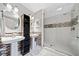 Bathroom with dual sinks, modern lighting, and glass shower at 3919 Evans Rd, Cumming, GA 30040